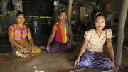Daw Than Than Sein, U Win Hlaing, and daughter Win Win Thu at their home in the Ayeyarwaddy River Delta village of Wakouktaw; Proximity Designs&rsquo; irrigation equipment has helped them expand their farm and boost their income significantly. 
