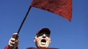 Bill Markus &rsquo;60 waving the Little Red Flag at Yale Bowl (see <a href="http://harvardmagazine.com/2003/09/superfan.html">“Superfan”</a>). Crimson loyalists have taken the flag to 124 Yale games since 1884; on Markus&rsquo;s watch, Harvard is now 12-1. 