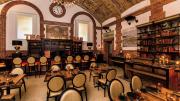 Cozy Map Room Tea Lounge with books, bar, and vaulted ceiling