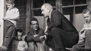 Historic photograph of President Lyndon Johnson meeting with impoverished Fletcher family in Kentucky in 1964