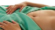 A patient undergoes acupuncture of the belly