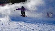 Skier coasting down the mountain with snow sprays