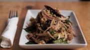 An appetizer of ground pork with onions and basil