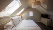 Sunlight flows into a Warfield House Inn bedroom