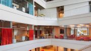A second, smaller atrium includes a graduate-student lounge, a glassed-in level with red furniture.