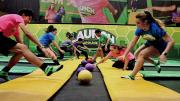 People playing dodgeball on indoor trampolines 