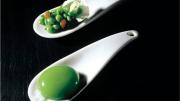 One of the first "spherical" dishes tried at elBulli: the large oval "raviolo" has a gelatinous shell and a liquid center, and tastes of peas; the second spoon contains a salad of fresh peas and mint oil.
