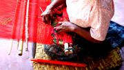 A weaver works on a traditional Mayan back strap loom in Guatemala in 2007. 
