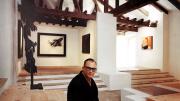 In a 1966 image taken in the Museum of Abstract Spanish Art in Cuenca, Zóbel holds one of his sketches; his painting <em>Ornitóptero</em> hangs behind him. At left is <em>Homenaje a Vasarely II,</em> a sculpture by Amadeo Gabino; the painting at far right is <em>Barrera con rojo y ocre,</em> by José Guerrero.