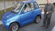 Jeffrey Leonard proudly drives a REVA electric car.