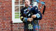 Photograph by Harvard Magazine/VL May 27, 2010 - Bagpiper Ian Massie of Wrentham, Massachusetts, led one contingent of the alumni procession on Thursday afternoon. He wears the Macbeth tartan.