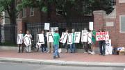 Union members from AFSCME protest potential layoffs at Harvard on Commencement day.