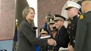 President Drew Faust presented each newly commissioned officer with a copy of <i>Just and Unjust Wars</i> by Michael Walzer.