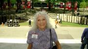 Betty Breck stands on Widener Library steps, with some of the 21,000 chairs set up in Tercentenary Theatre for the 2010 Commencement in the background.  There were 15 times more chairs set up than residents in Breck's hometown of Groton, South Dakota.
