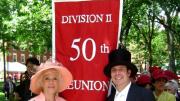 Betty Breck and marshal Don DeSollar flank the reunion banner, with members of the Class of 1960 in the background, prepared to march in the alumni/ae procession at the 2010 Commencement.