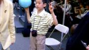 Unidentified young man attending 2010 Commencement has the world at his fingertips.