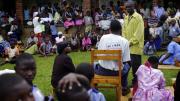 For an audience of patients waiting to be seen outside the clinic, the troupe performs a skit about parenting skills.