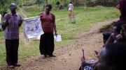 Kiahana Brooks ’10 (right) teaches about malaria prevention and treatment to patients waiting to be seen at the clinic. Clinic worker Richard Kimanayi, left, translates.