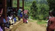 Patients waiting at the Beatrice Tierney Health Center listen to a lesson about malaria.