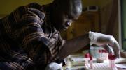A clinic worker handles blood samples. This clinic offers something unusual for a rural clinic: a staff physician and free, rapid HIV testing each weekday.