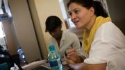 Lecturer on medicine Krista Dong directs iTEACH, a set of innovative initiatives to improve HIV care in South Africa. In the background is iTEACH deputy director Zinhle Thabethe.