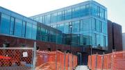 The brick-and-glass Northwest Science Building wends its way among existing structures along Hammond and Oxford streets.