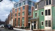 A new wood-frame building on Cowperthwaite Street softens the profile of a six-story brick-and-glass apartment complex.