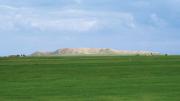 The high central mound of Tell Brak, formed by generations of mud structures built on top of one another, rises out of the alluvial plain.