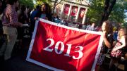 Seniors Kia J. McLeod (left) and Andrea R. Flores, vice president and president of the Undergraduate Council, display the banner that they presented to the class of 2013.
