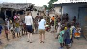 After the group's van broke down, Audrey White ’10 and Kim Kargman ’11 attempted to learn some traditional games from Ghanaian children. The children found the <em>obrunis'</em> ("foreigners") lack of skill amusing, says White.