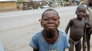 Among the group of children, a comedian mugs for the camera.