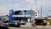 On Oxford Street, in the busy Osu section of Accra, glass-fronted bank buildings represent the nation's developing future.