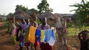On the orphanage grounds, children hang laundry to dry.