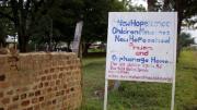 A sign on the road identifies the orphanage.