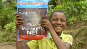 A young (and proud) recipient of a GMin mosquito net