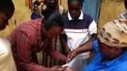 The people of Kibera are nothing if not resourceful. Here, the women use a candle flame to fuse together two ends of a piece of plastic, to form it into a loop they’ll use for a planter.