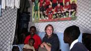 Nowak visits Obado's home. At left are Obado's son Carlos, and her sister.