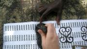 Stamping a piece of kente cloth with Adinkra symbols in Ntonso. Although Adinkra is sometimes cast as a closed system of symbols passed down through history, Ryan learned that the system is rather “something fluid that’s constantly in the making,” she says. “New symbols are being created every day. They’re not considered not to be Adinkra just because they’re being created now.”