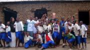 Jasrasaria first visited Arusha as a volunteer for Support for International Change (SIC), a U.S.-based NGO that conducts HIV education, counseling, and testing. Here, Jasrasaria (back row, right) poses with American volunteers, Tanzanian teaching partners, and children who took part in an afterschool “Fight HIV/AIDS Club” the SIC volunteers led.