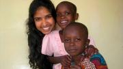 Rashmi Jasrasaria ’10 investigated several topics, including some research that involved visiting partner organizations of the Arusha Project, the nongovernmental organization (NGO) that was hosting her as a researcher. Here, she is shown with two children who attend the Baraa Orphanage and Nursery School, whose directors are both HIV-positive.