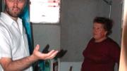Ortega (right) talks with ELEMENTAL project manager Gonzalo Arteaga in the bathroom of her home. Despite the unfinished walls, residents are pleased that the bathroom in each unit has a bathtub and a window that opens.