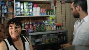 Marta Herrera, pictured with ELEMENTAL project manager Gonzalo Arteaga, has set up a small convenience store in the front room of her house at the Lo Espejo development.
