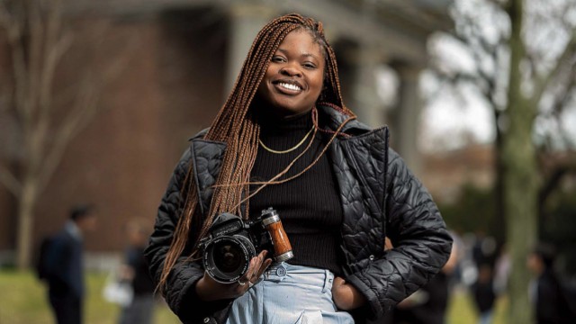 Dumb Menakaya standing on campus with her camera