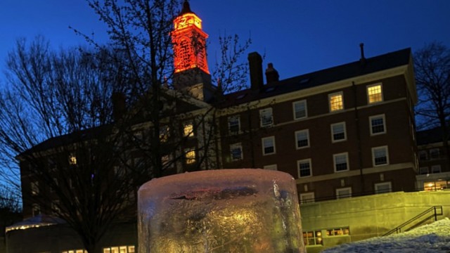Close-up image of an "ice lantern" (a light set in an ice casing) in the snow on Radcliffe Quad