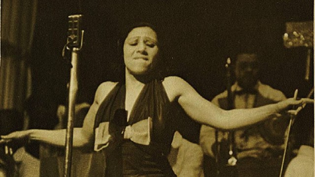 Blanche Calloway spreading her arms during a performance