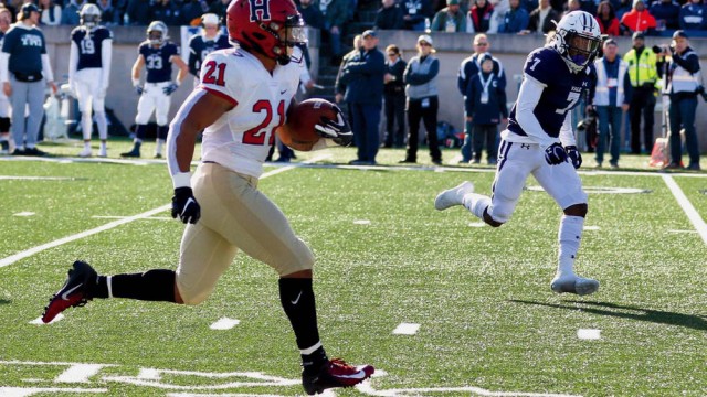 Photograph: With Yale’s Melvin Rouse II in vain pursuit, Harvard’s Aidan Borguet heads for the goal line.