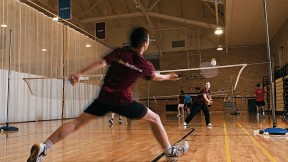 A badminton rally in progress at the Malkin Athletic Center. 