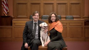 Chris Green and Kristen Stilt in Austin Hall’s Ames courtroom with Lola, Stilt’s rescue dog from Egypt