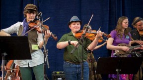 Three fiddlers playing