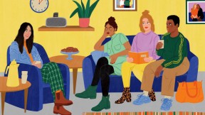 Four young women of different ethnic backgrounds converse in a homey lounge 